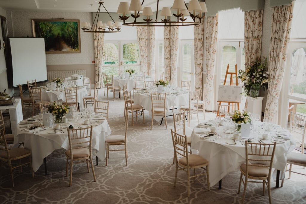 The Garden Room at Horsted Place Hotel set up with tables for a wedding breakfast