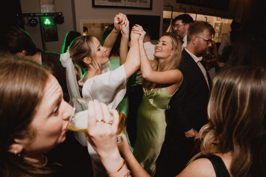 Bride dancing with her friend on the danceflorr at The Lordship pub